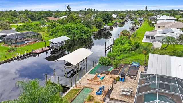 an aerial view of multiple houses with yard