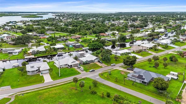 an aerial view of residential houses with outdoor space and street view
