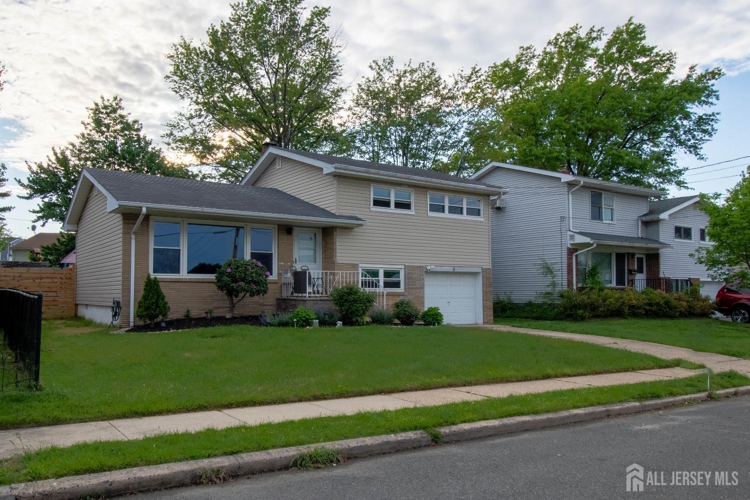 11 Monush Street South River, NJ 08882 - Photo 1 of 25 a front view of a house with a yard and garage