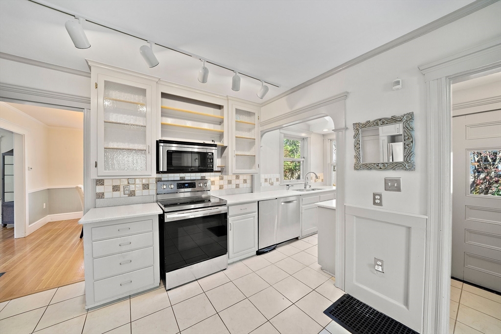 11 Gordon Road Needham, MA 02492 - Photo 18 of 42 a kitchen with stainless steel appliances a stove sink and cabinets