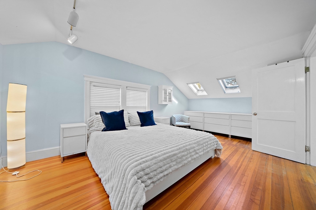 11 Gordon Road Needham, MA 02492 - Photo 22 of 42 a bedroom with a bed and wooden floor