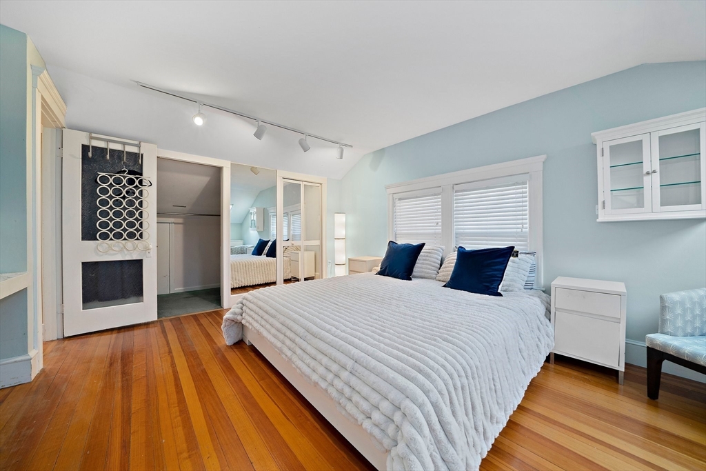 11 Gordon Road Needham, MA 02492 - Photo 24 of 42 a spacious bedroom with a bed and a flat screen tv