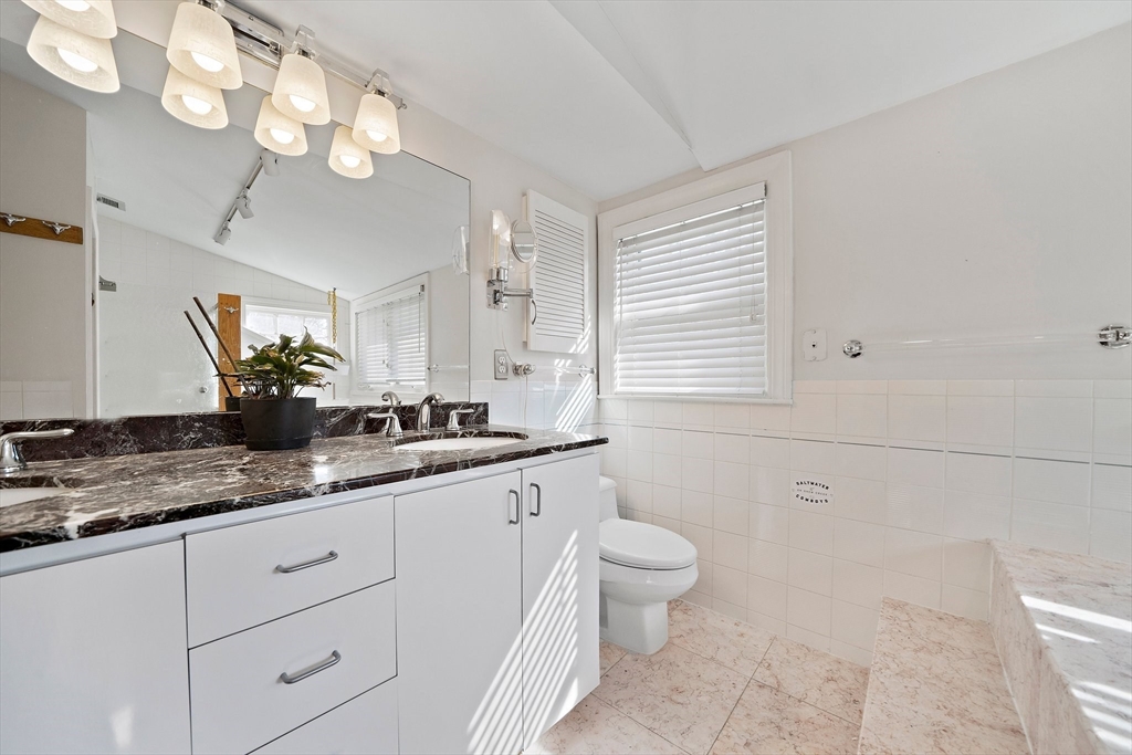 11 Gordon Road Needham, MA 02492 - Photo 25 of 42 a bathroom with a granite countertop sink a toilet and mirror