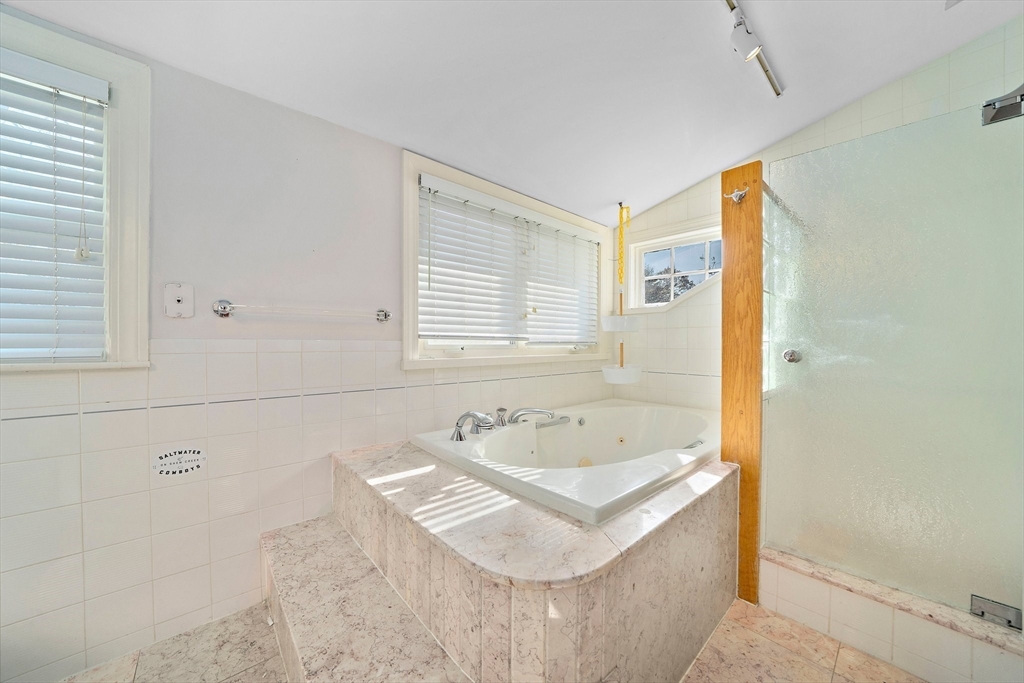 11 Gordon Road Needham, MA 02492 - Photo 26 of 42 a bathroom with a tub sink and mirror