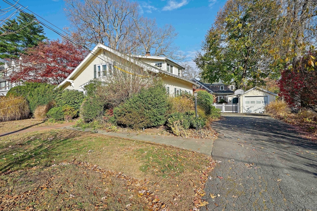 11 Gordon Road Needham, MA 02492 - Photo 3 of 42 a front view of a house with a yard and garage