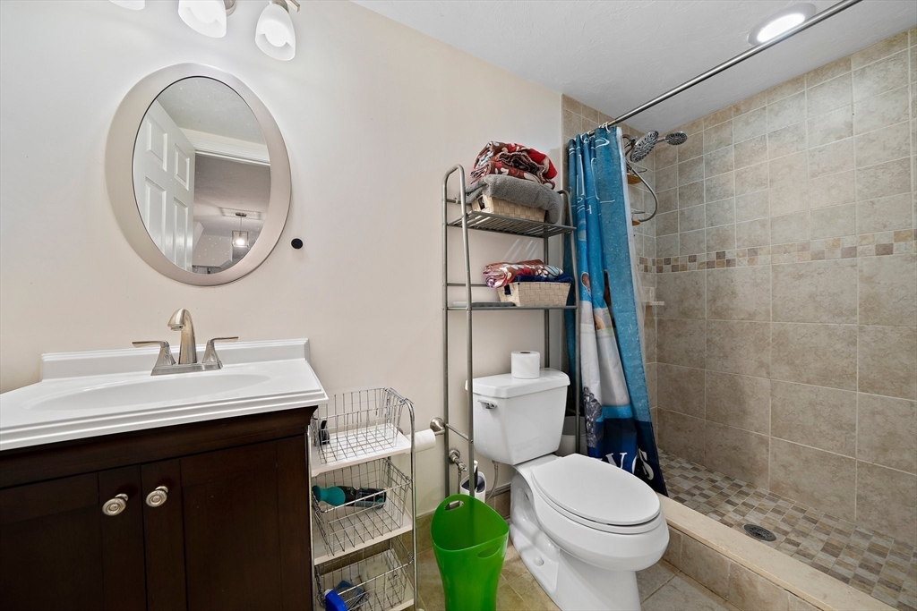 11 Gordon Road Needham, MA 02492 - Photo 33 of 42 a bathroom with a toilet sink vanity and mirror