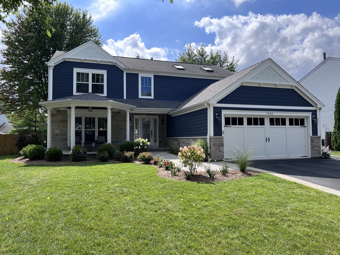 1400 Glacier Parkway Algonquin, IL 60102 - Photo 1 of 34 a front view of a house with a garden and porch