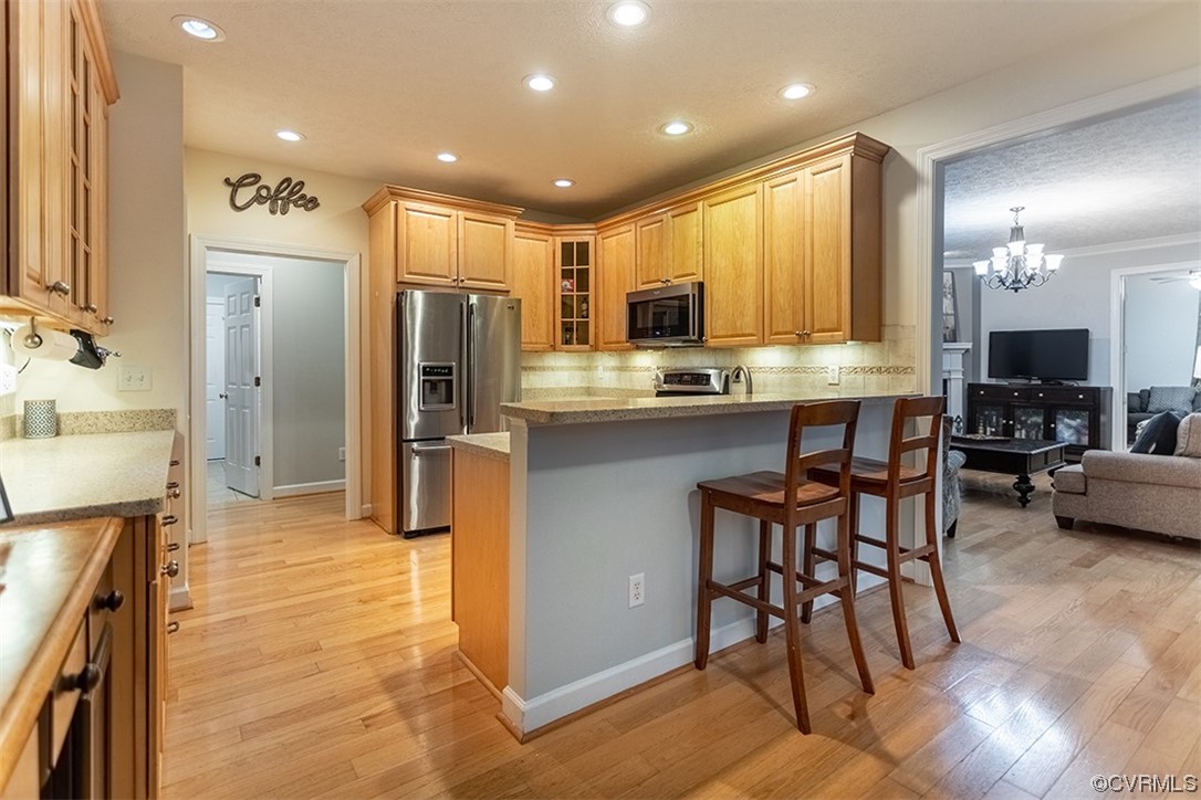 11570 Royal Lane Providence Forge, VA 23140 - Photo 11 of 49 a kitchen with kitchen island granite countertop wooden cabinets and refrigerator