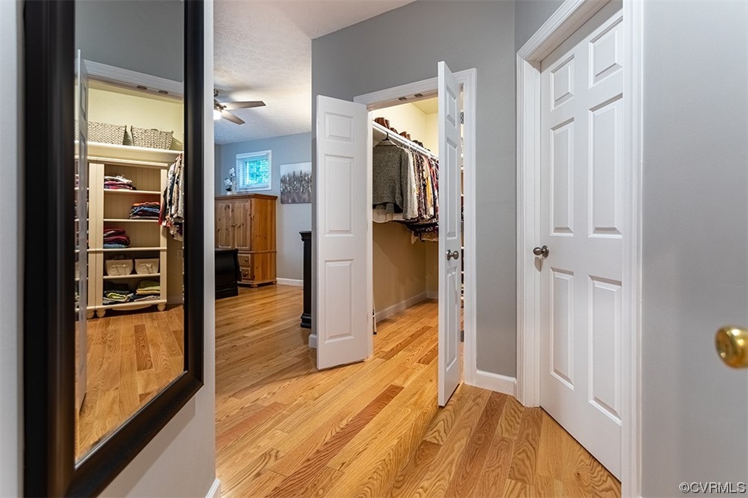 11570 Royal Lane Providence Forge, VA 23140 - Photo 15 of 49 a view of a hallway with wooden floor and a living room