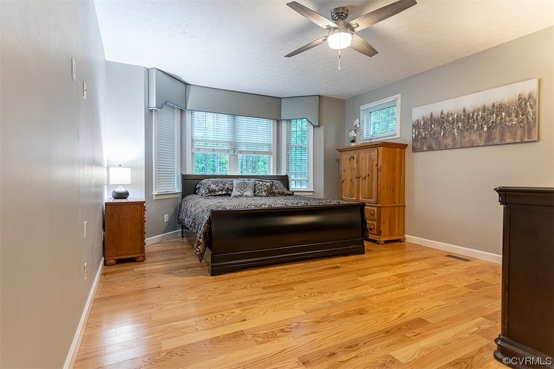 11570 Royal Lane Providence Forge, VA 23140 - Photo 16 of 49 a bedroom with a bed and wooden floor