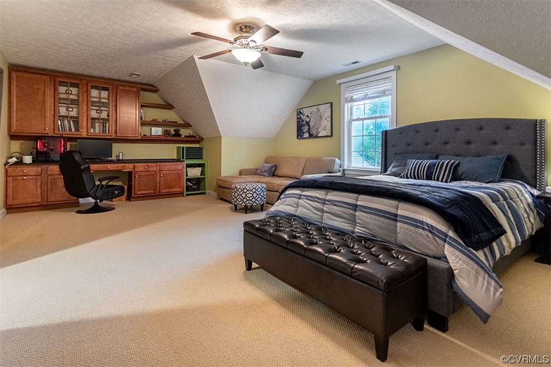11570 Royal Lane Providence Forge, VA 23140 - Photo 36 of 49 a spacious bedroom with a bed couch chandelier and a window
