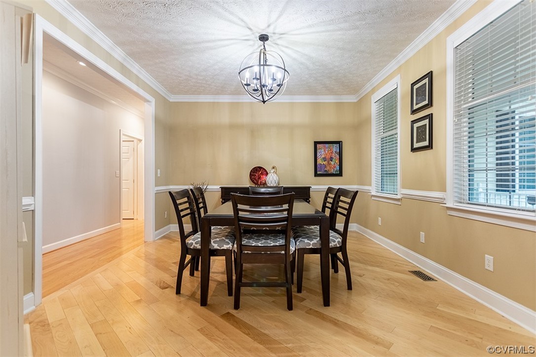 11570 Royal Lane Providence Forge, VA 23140 - Photo 8 of 49 a dining room with furniture a rug and a chandelier