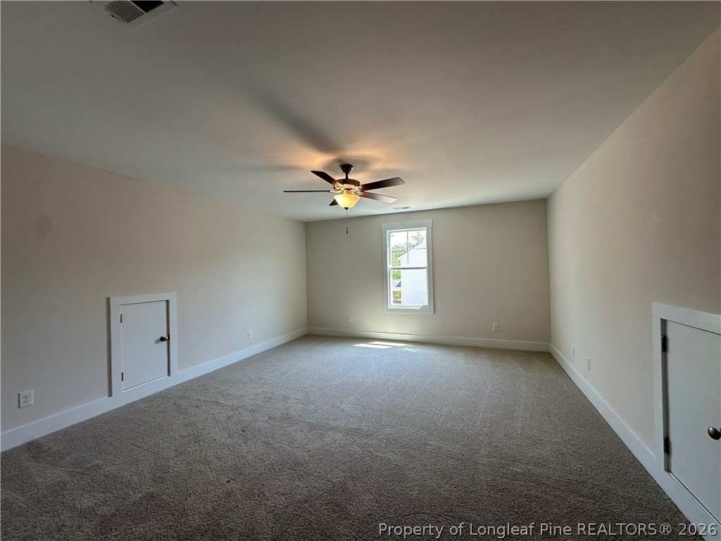 2908 Calloway Road Raeford, NC 28376 - Photo 19 of 25 an empty room with a window and a ceiling fan