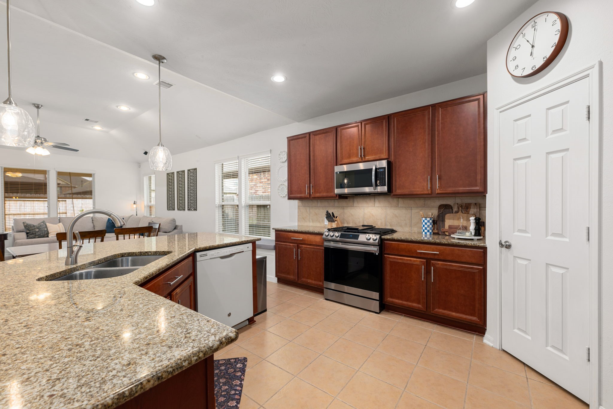 24014 Adobe Ridge Lane Katy, TX 77493 - Photo 12 of 45 a kitchen with stainless steel appliances granite countertop a stove top oven a sink a stove and a refrigerator