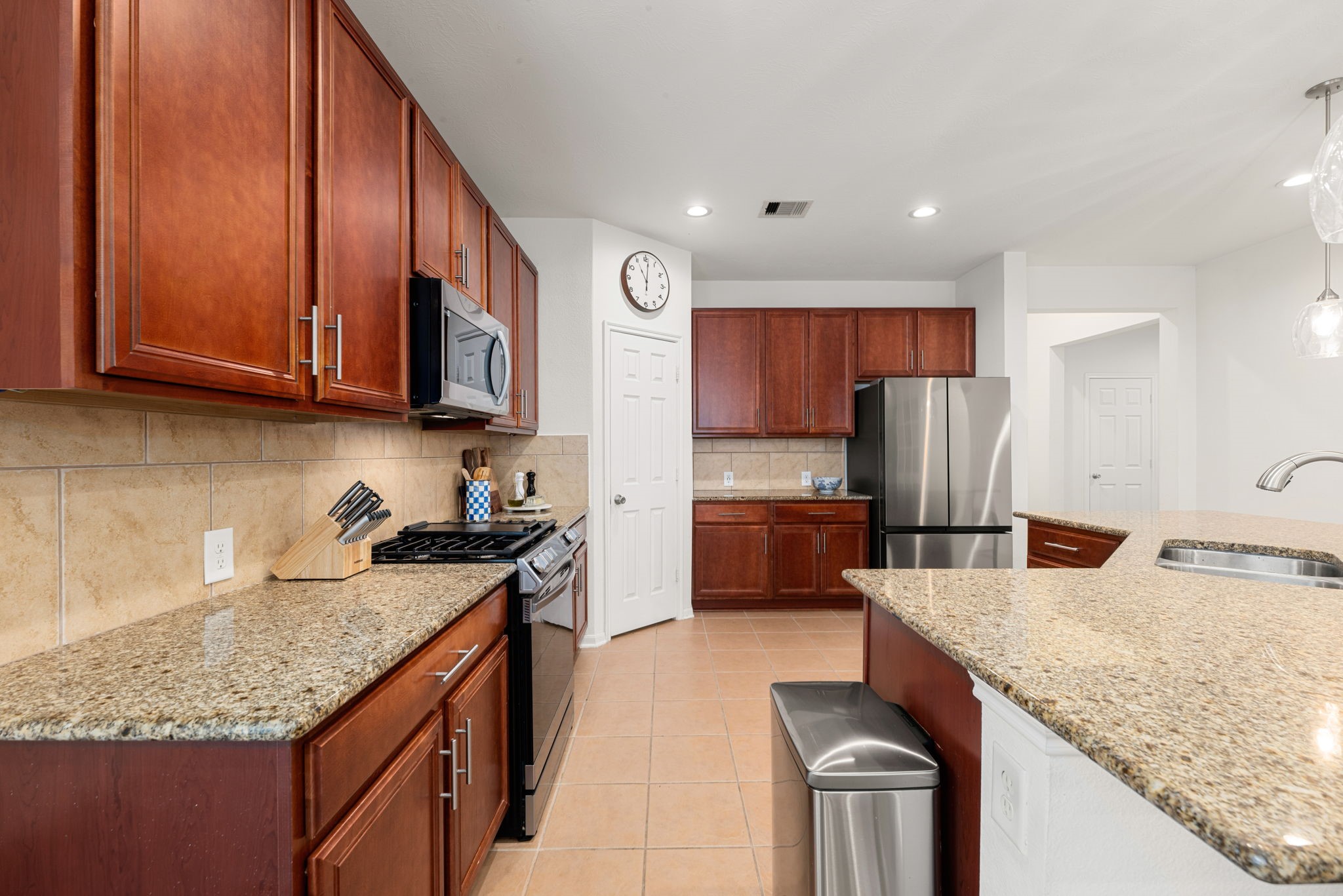24014 Adobe Ridge Lane Katy, TX 77493 - Photo 13 of 45 a kitchen with a refrigerator sink and microwave