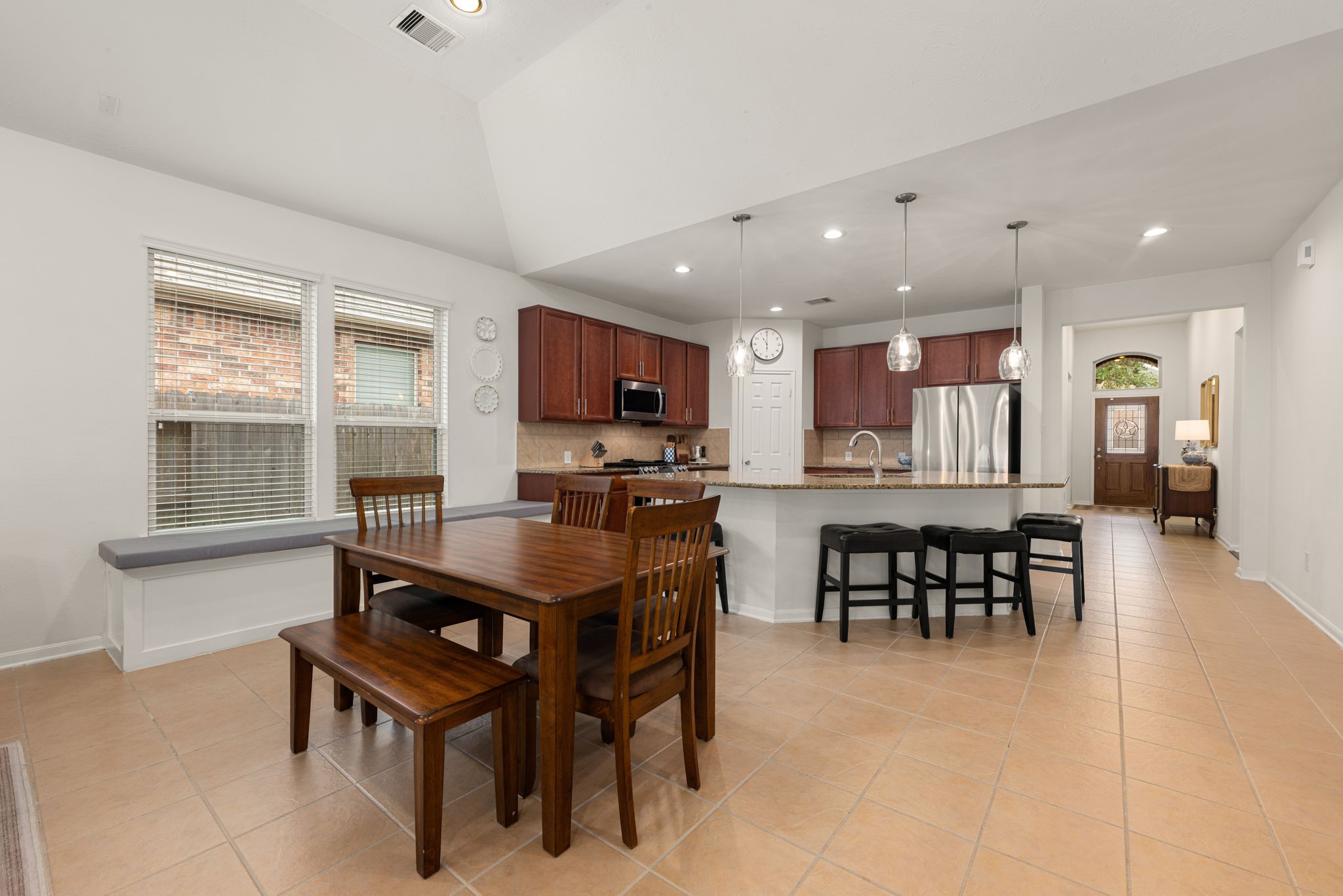 24014 Adobe Ridge Lane Katy, TX 77493 - Photo 14 of 45 a dining room with kitchen island furniture a window and appliances