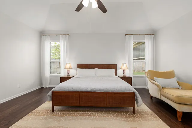 a bedroom with a bed couch and window