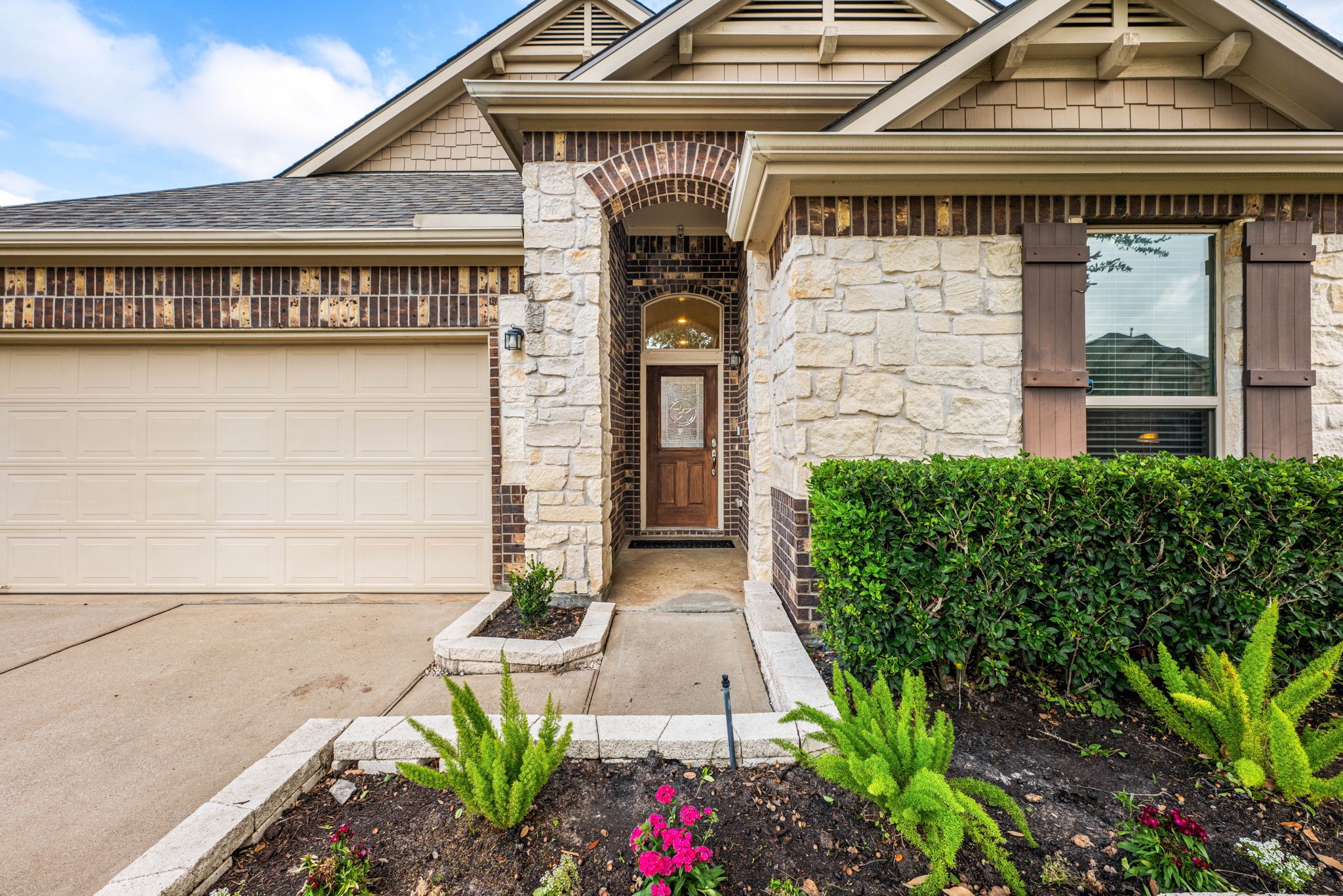 24014 Adobe Ridge Lane Katy, TX 77493 - Photo 2 of 45 a front view of a house with potted plants
