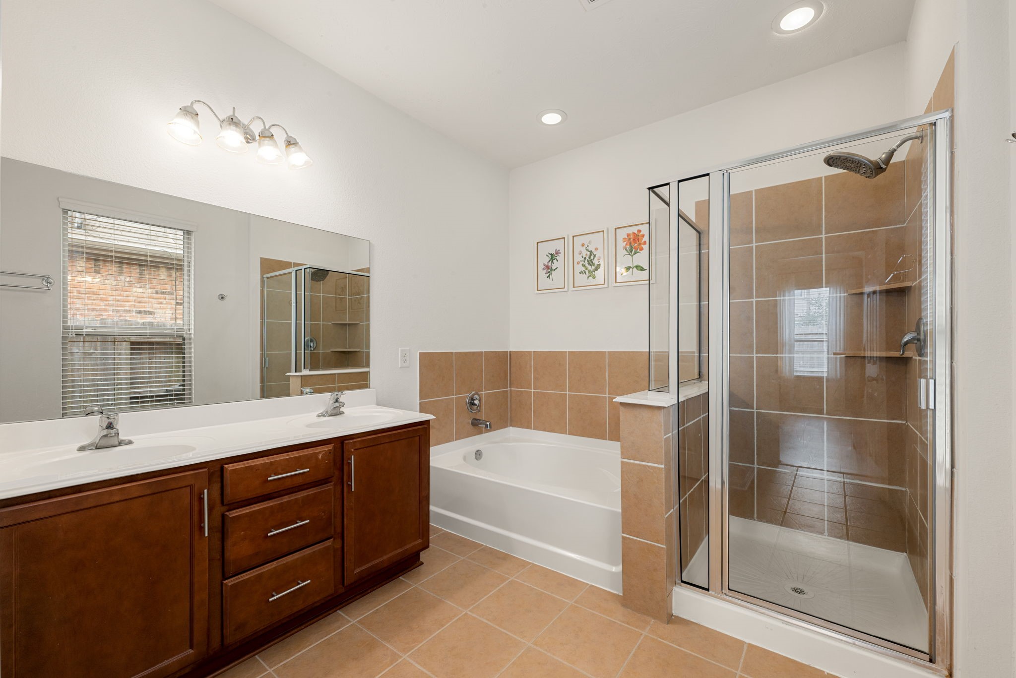 24014 Adobe Ridge Lane Katy, TX 77493 - Photo 22 of 45 a bathroom with a tub a sink shower and mirror