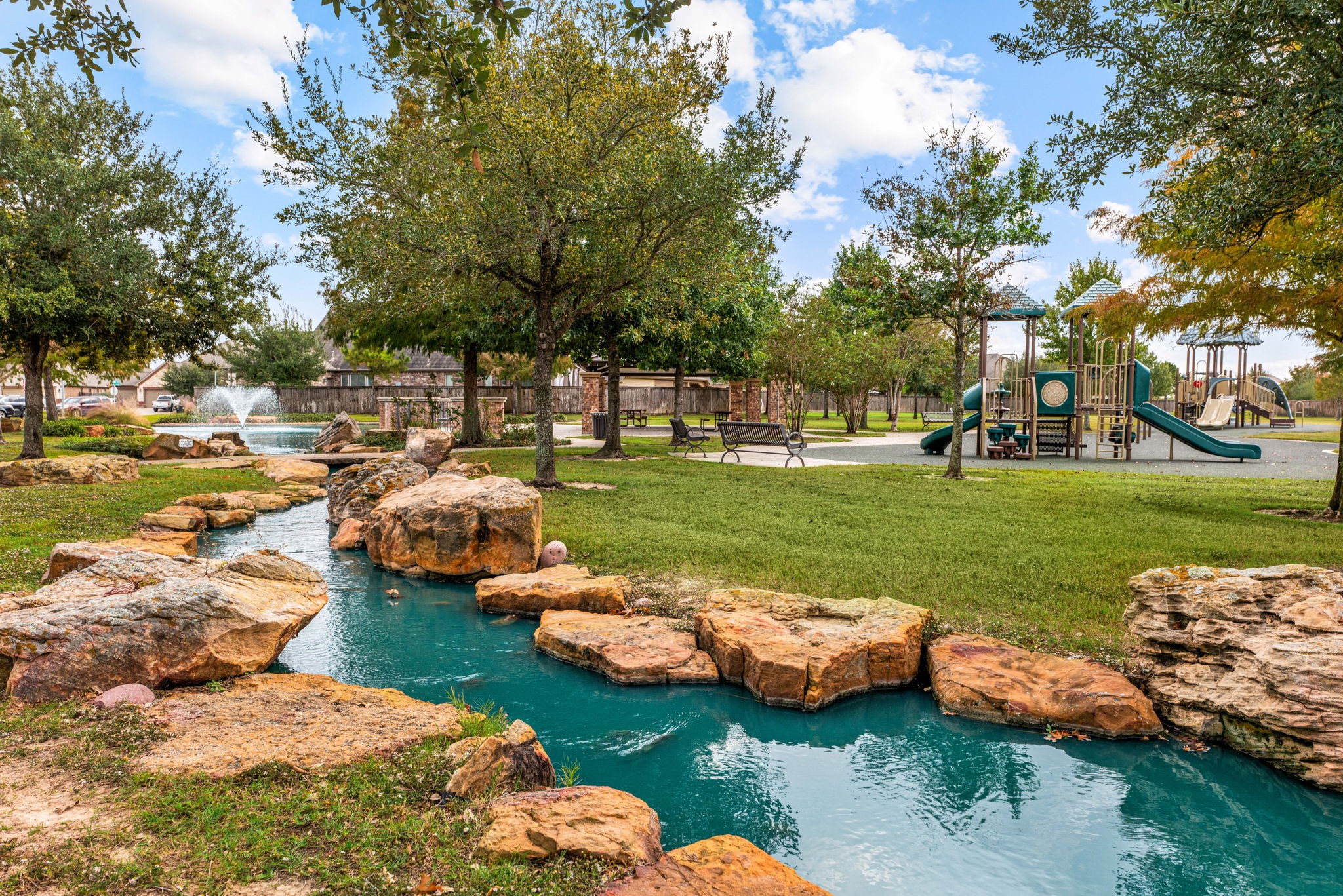 24014 Adobe Ridge Lane Katy, TX 77493 - Photo 34 of 45 a view of a lake with lawn chairs and large trees