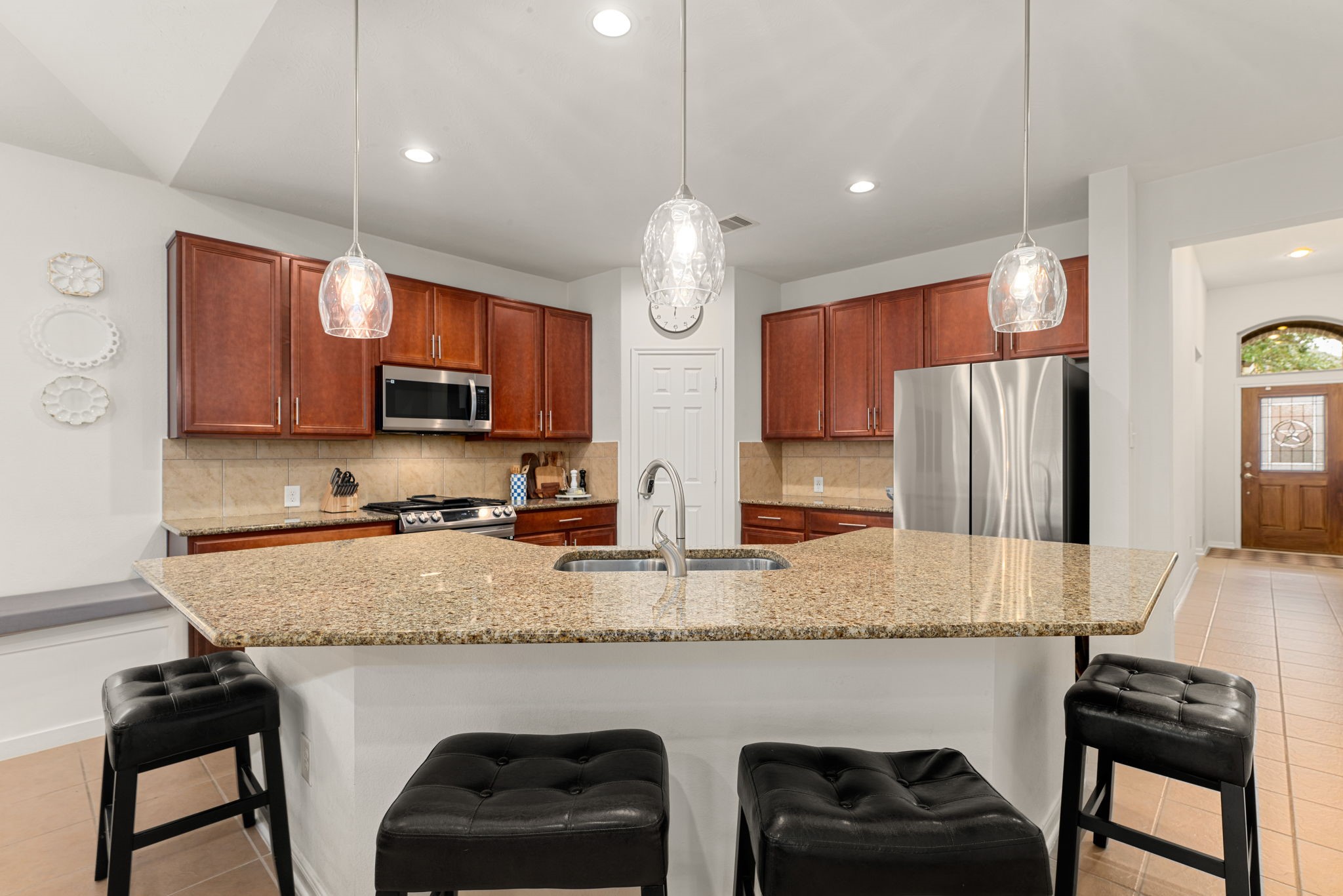 24014 Adobe Ridge Lane Katy, TX 77493 - Photo 8 of 45 a kitchen with stainless steel appliances granite countertop a stove a sink dishwasher and a refrigerator with wooden cabinets