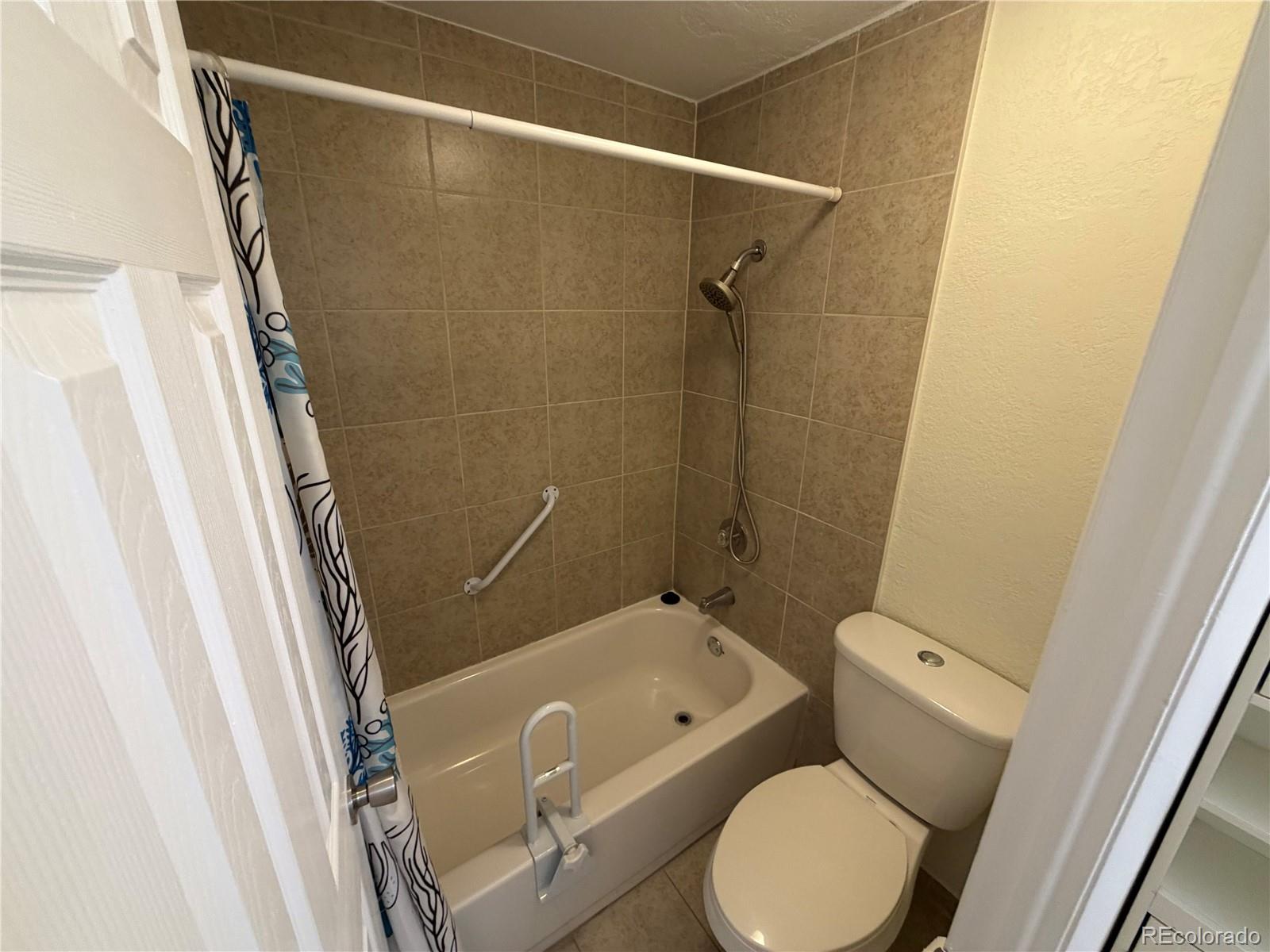 1304 South Parker Road, Unit 258 Denver, CO 80231 - Photo 6 of 9 a bathroom with a sink and toilet