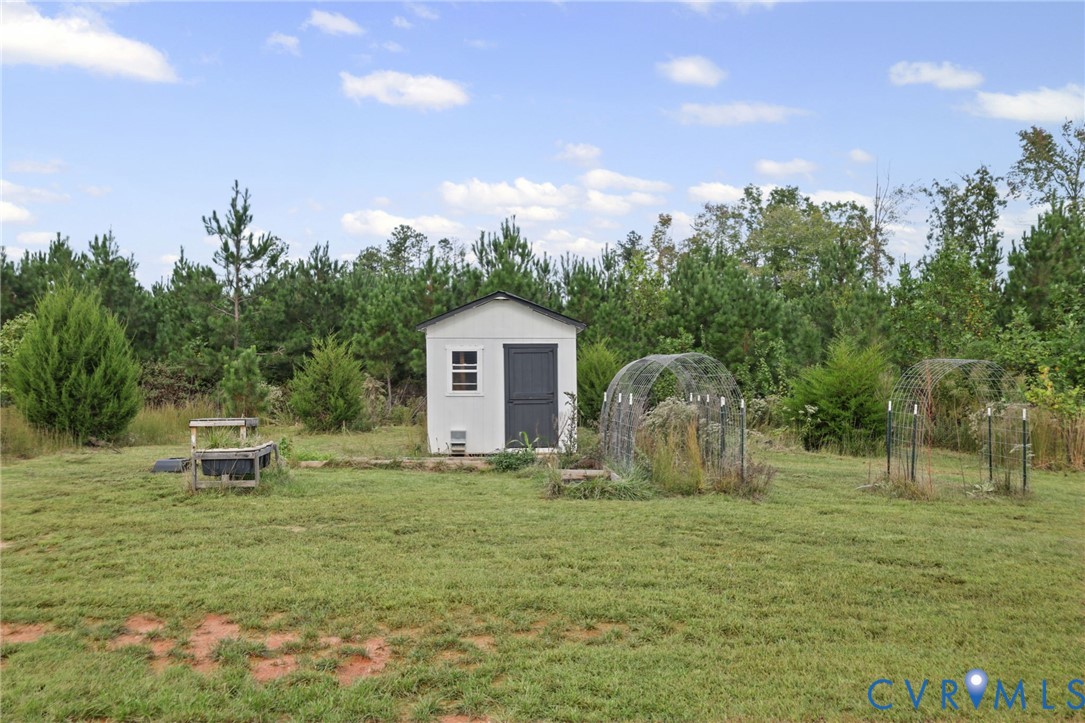 115 Jenkins Church Road Cumberland, VA 23040 - Photo 20 of 28 Detached storage shed with a dark gray door and wh