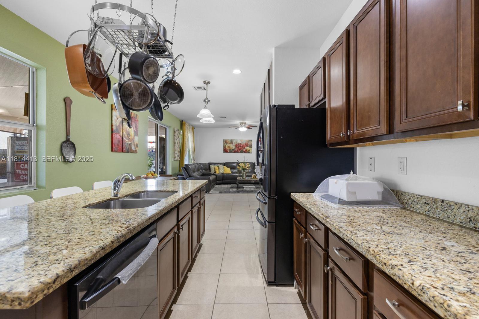 11501 Southwest 228th Lane Miami, FL 33170 - Photo 16 of 44 a kitchen with a sink a counter space and cabinets