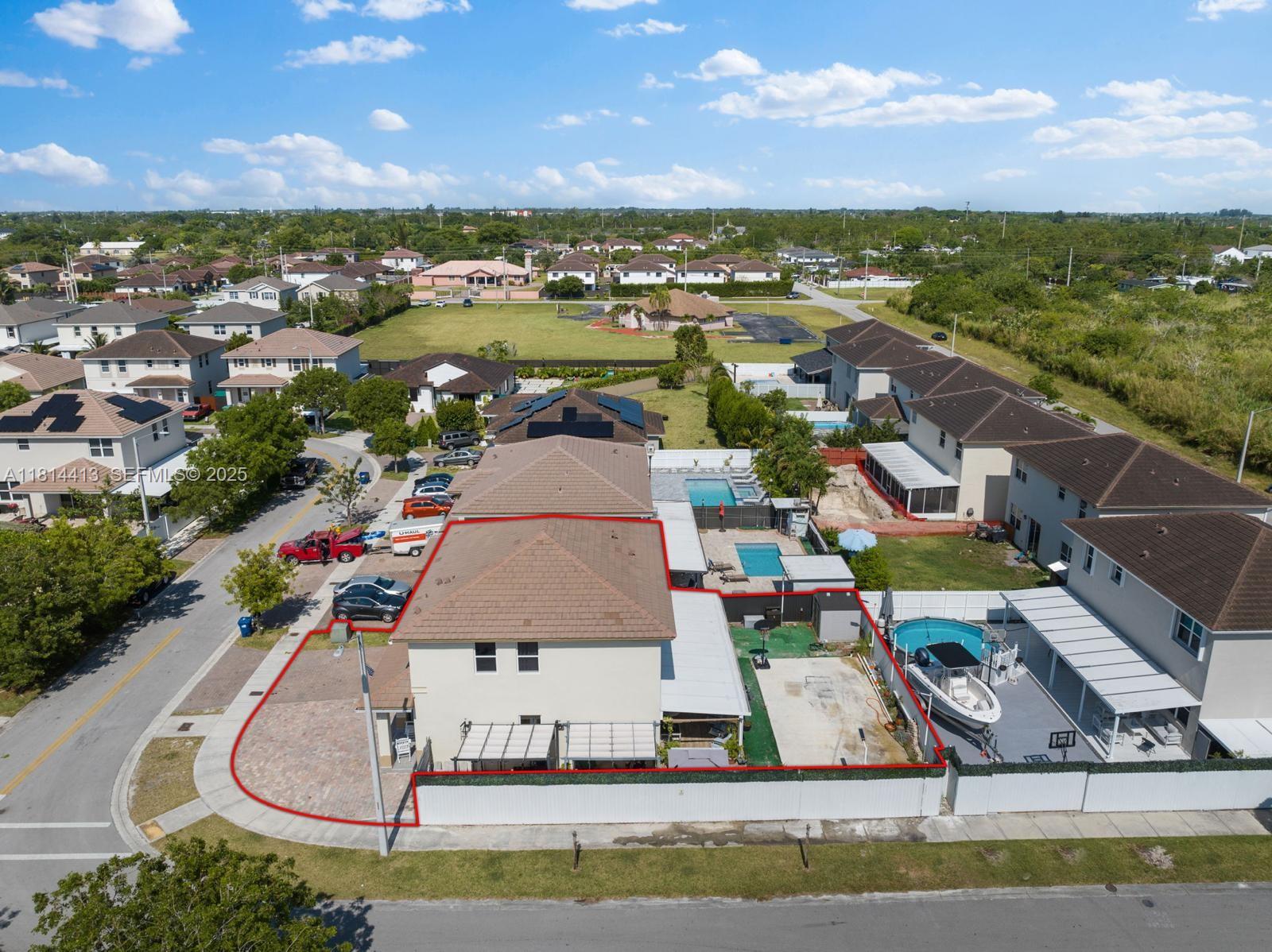 11501 Southwest 228th Lane Miami, FL 33170 - Photo 3 of 44 an aerial view of residential houses with outdoor space