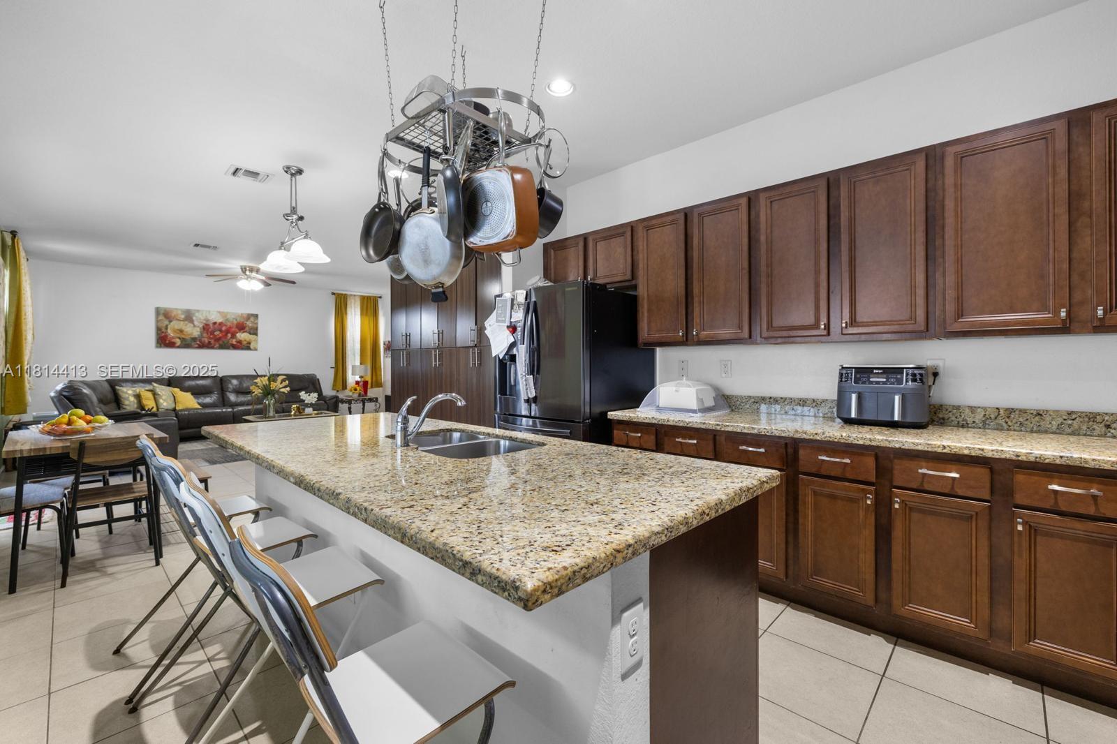 11501 Southwest 228th Lane Miami, FL 33170 - Photo 40 of 44 a kitchen with stainless steel appliances granite countertop a sink dishwasher and a stove with wooden floor