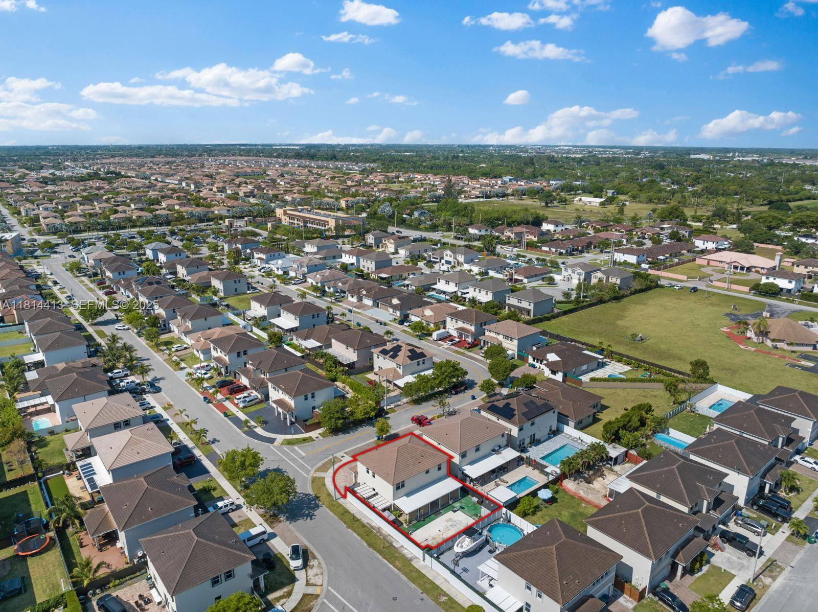 11501 Southwest 228th Lane Miami, FL 33170 - Photo 4 of 44 an aerial view of a city with lots of residential buildings