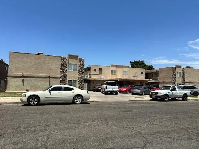 a view of cars parked in front of a building