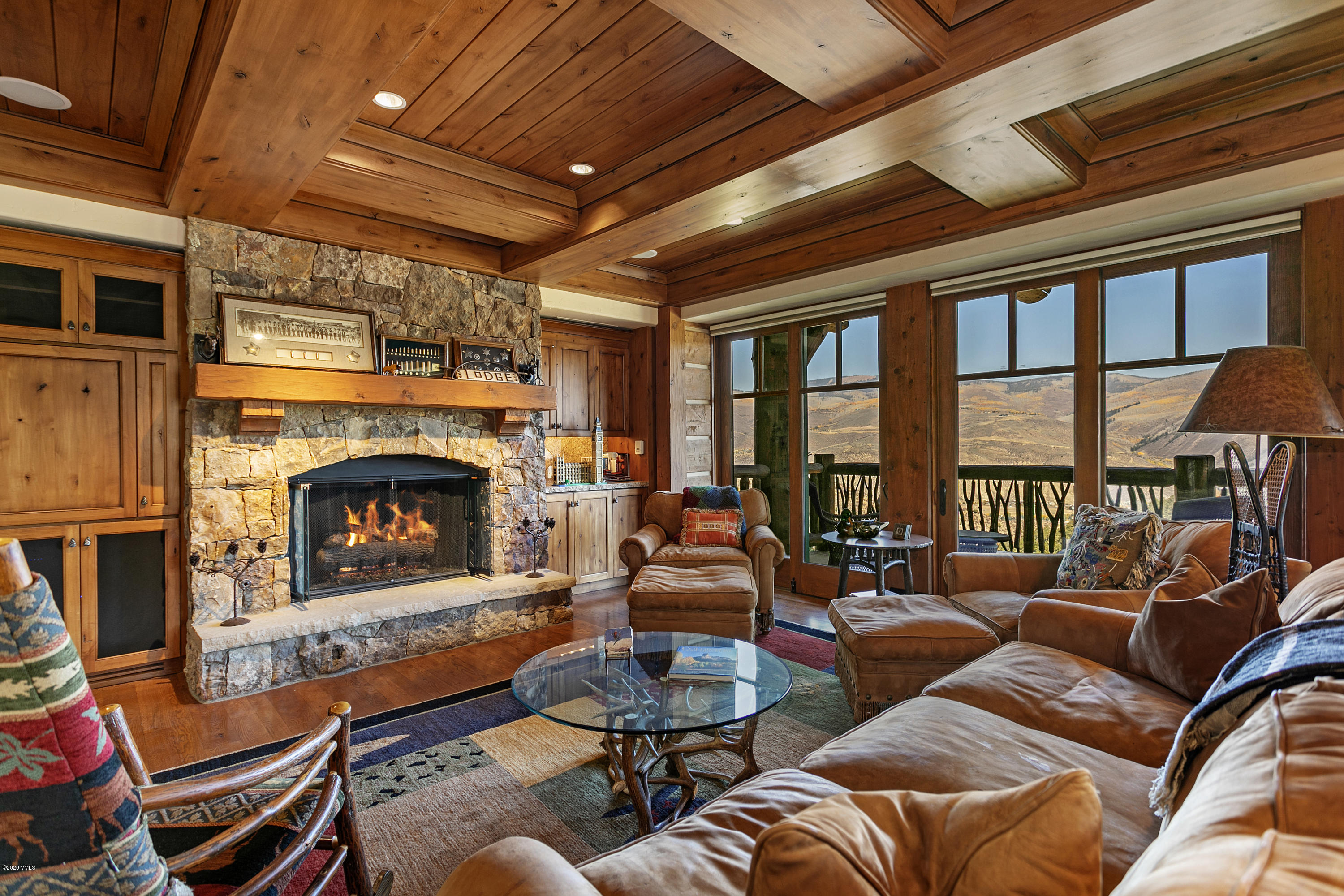 a living room with furniture large window and a fireplace