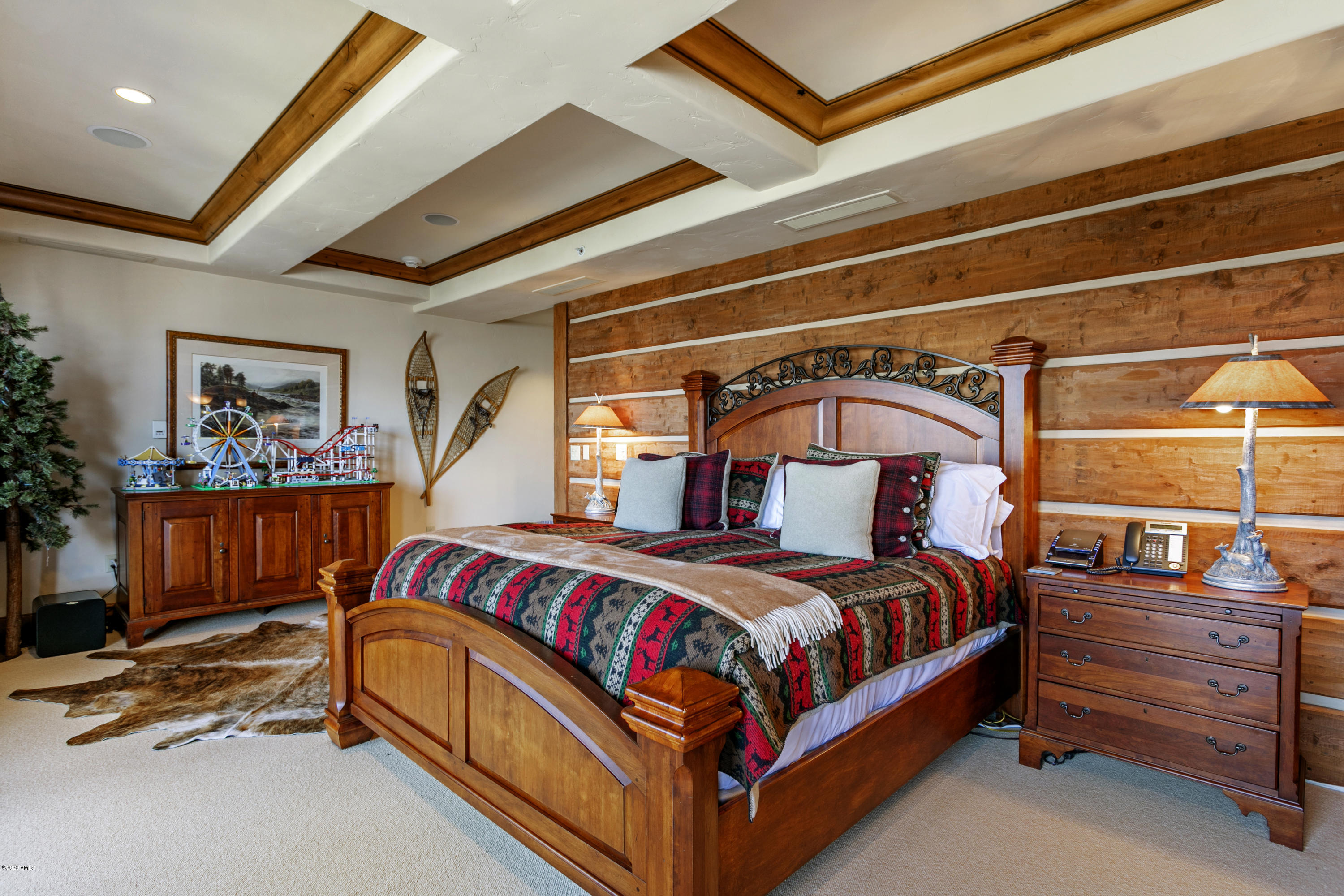130 Daybreak Ridge Road, Unit R906 Avon, CO 81620 - Photo 13 of 26 a bedroom with a bed and a dresser next to a window
