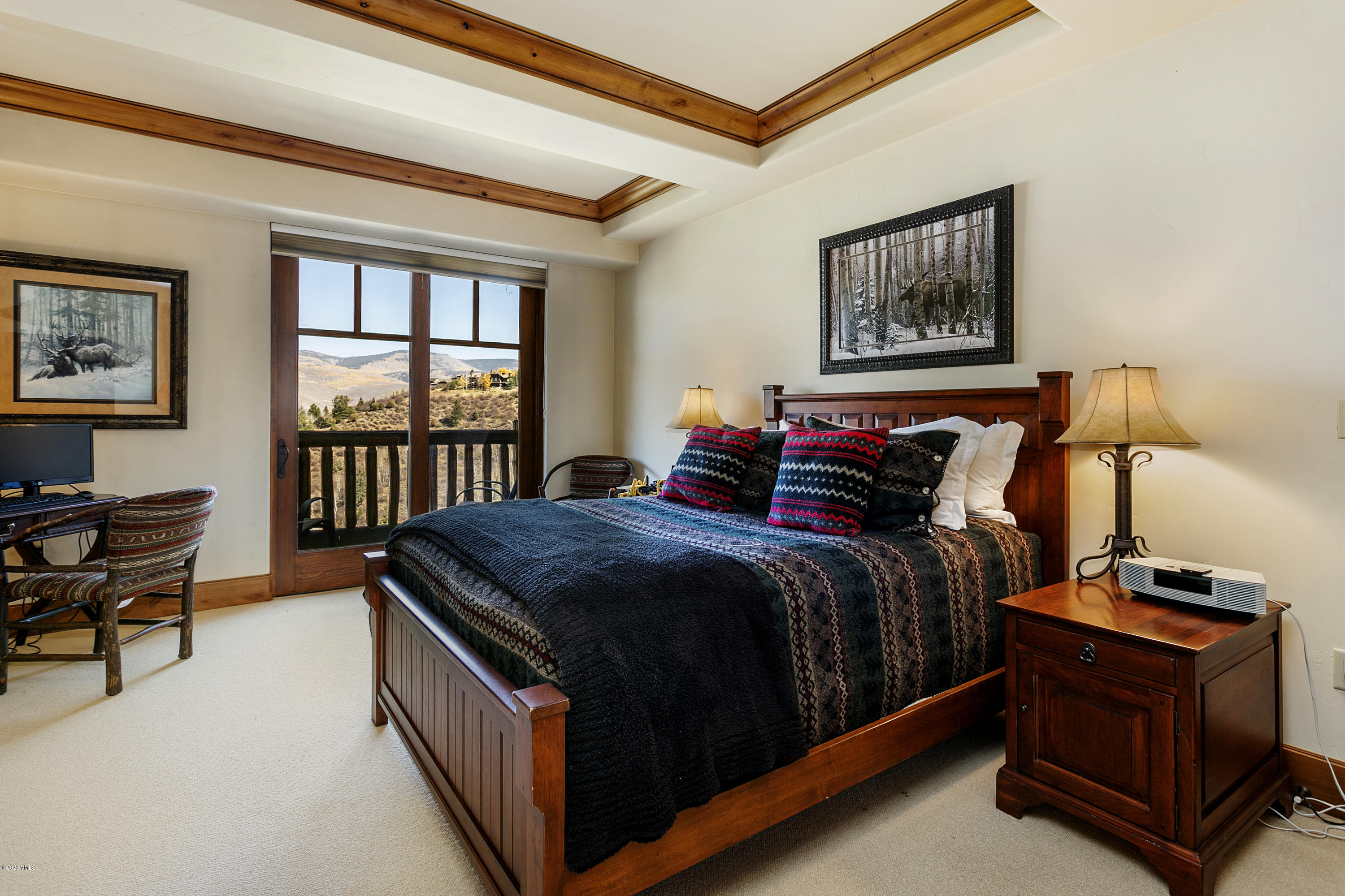 130 Daybreak Ridge Road, Unit R906 Avon, CO 81620 - Photo 17 of 26 a bed sitting in a bedroom next to a window