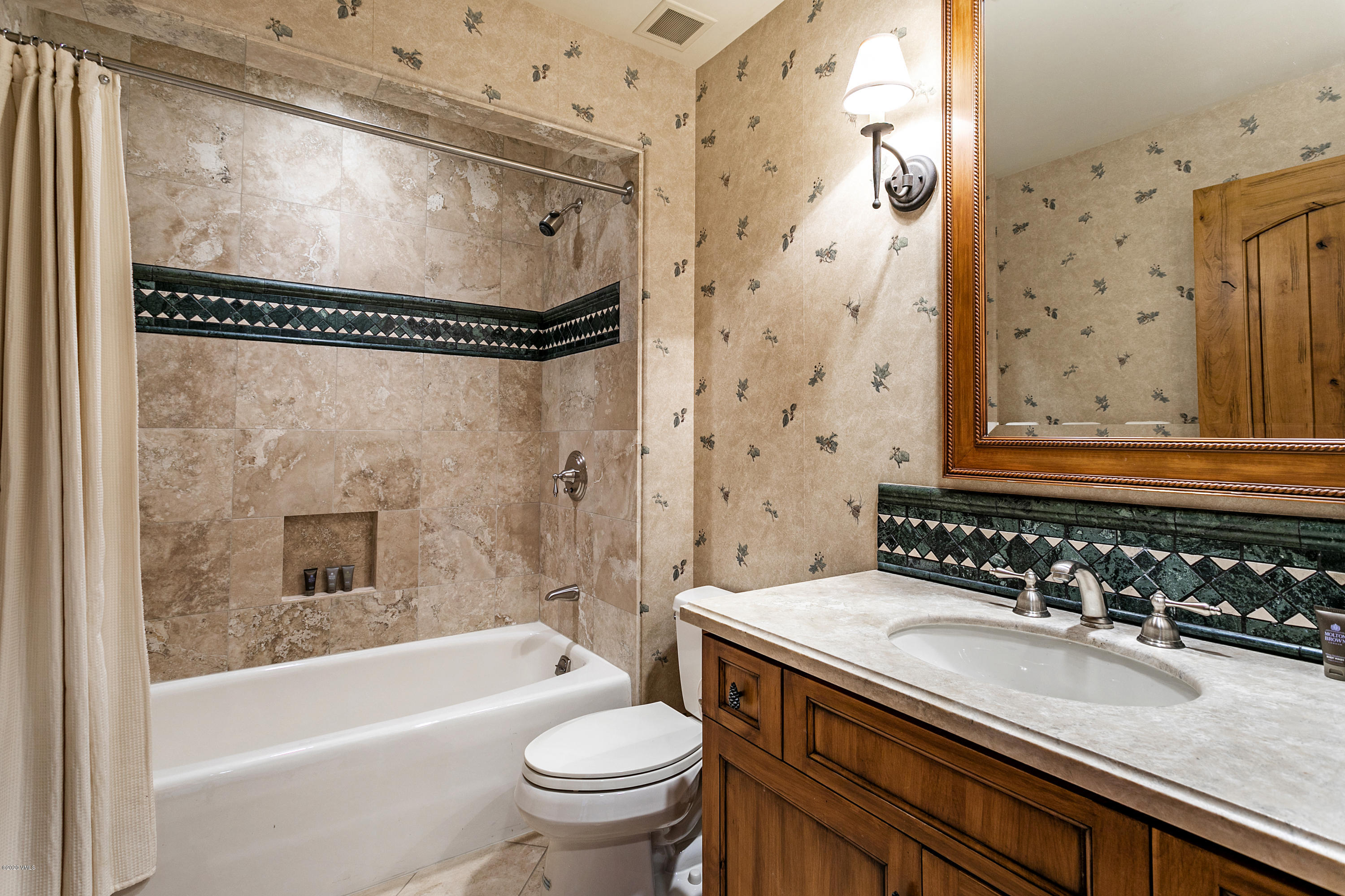 130 Daybreak Ridge Road, Unit R906 Avon, CO 81620 - Photo 19 of 26 a bathroom with a sink mirror toilet and bathtub
