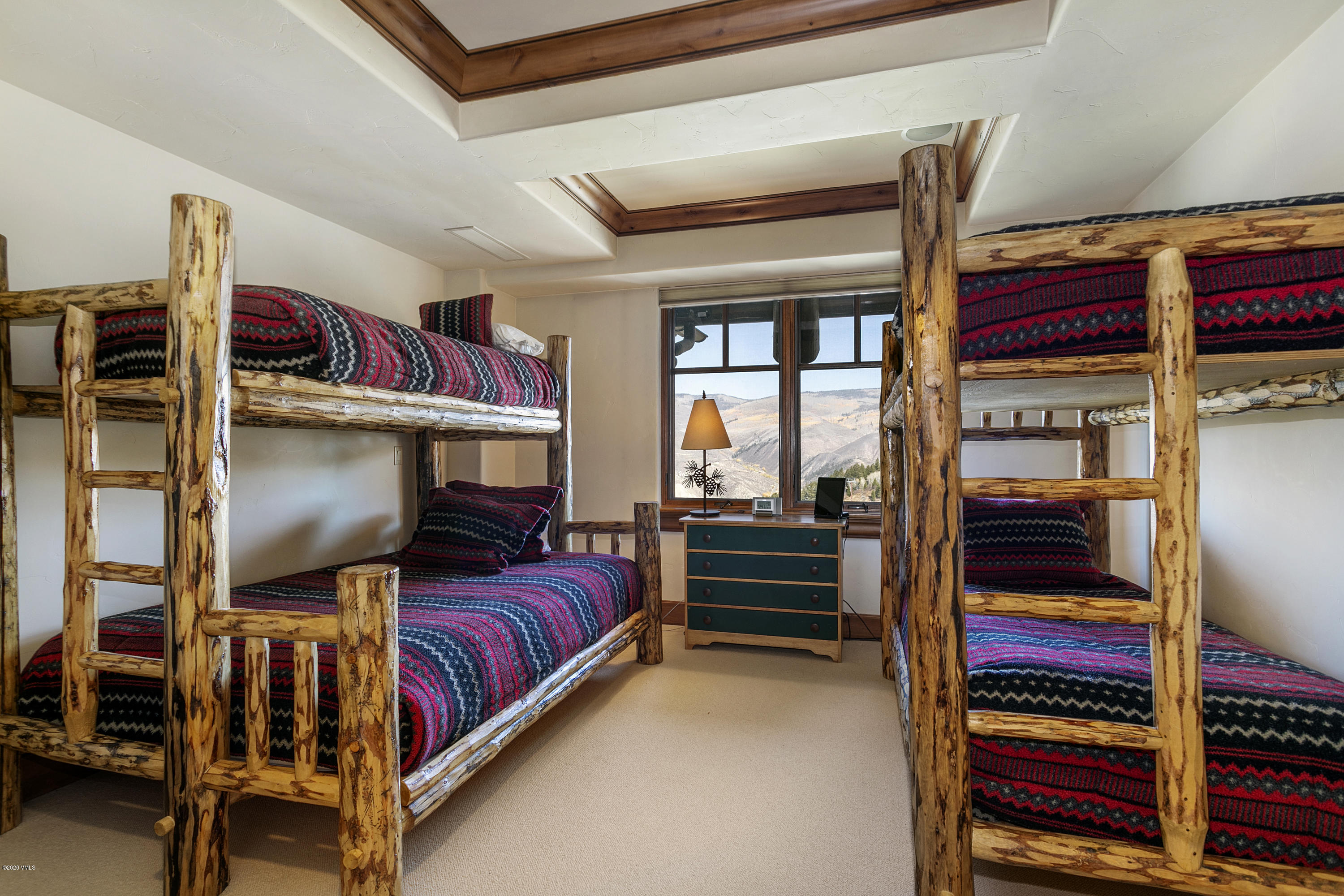 130 Daybreak Ridge Road, Unit R906 Avon, CO 81620 - Photo 20 of 26 a bed room with a bed and a window