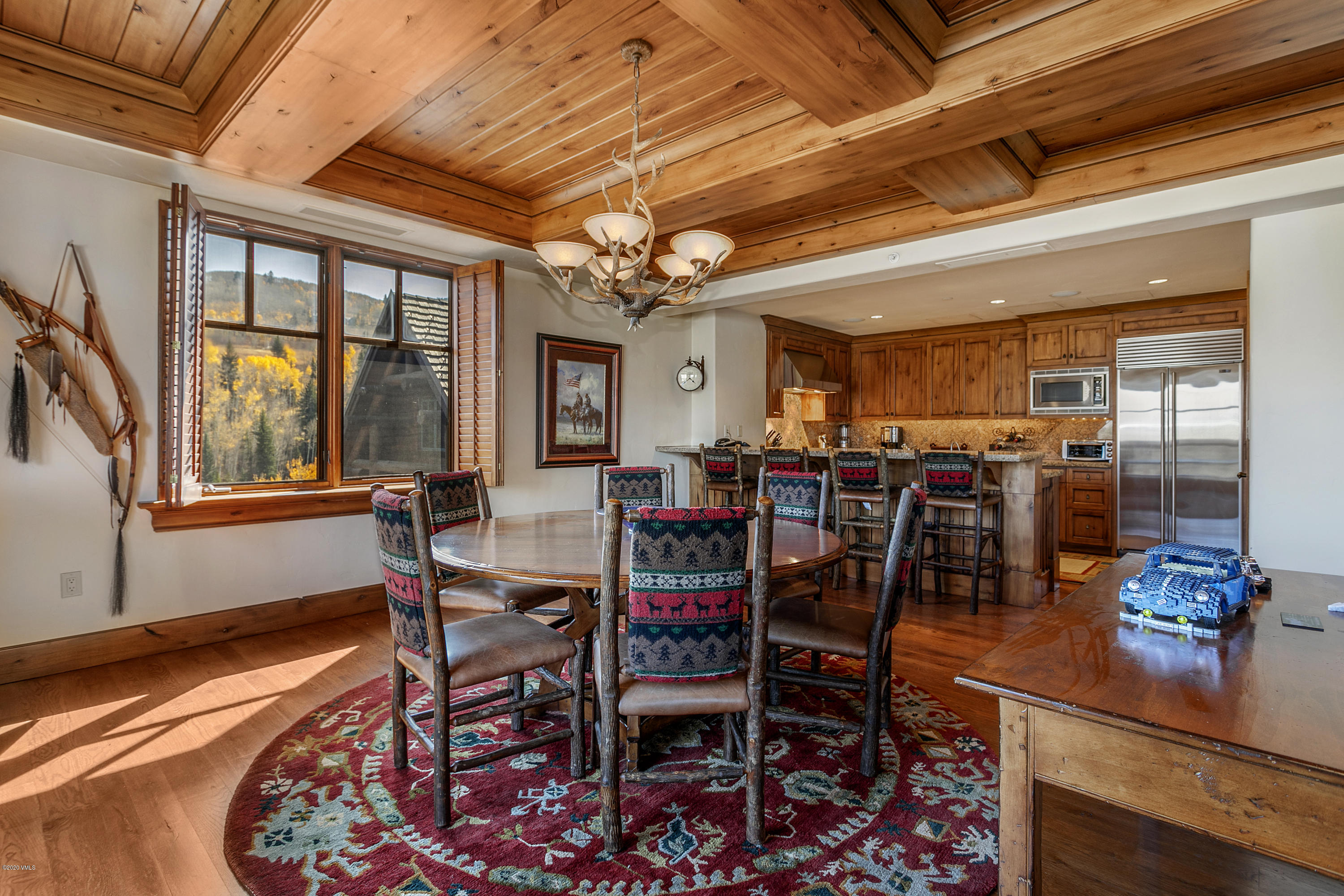 130 Daybreak Ridge Road, Unit R906 Avon, CO 81620 - Photo 3 of 26 a dining room with furniture a rug and a chandelier