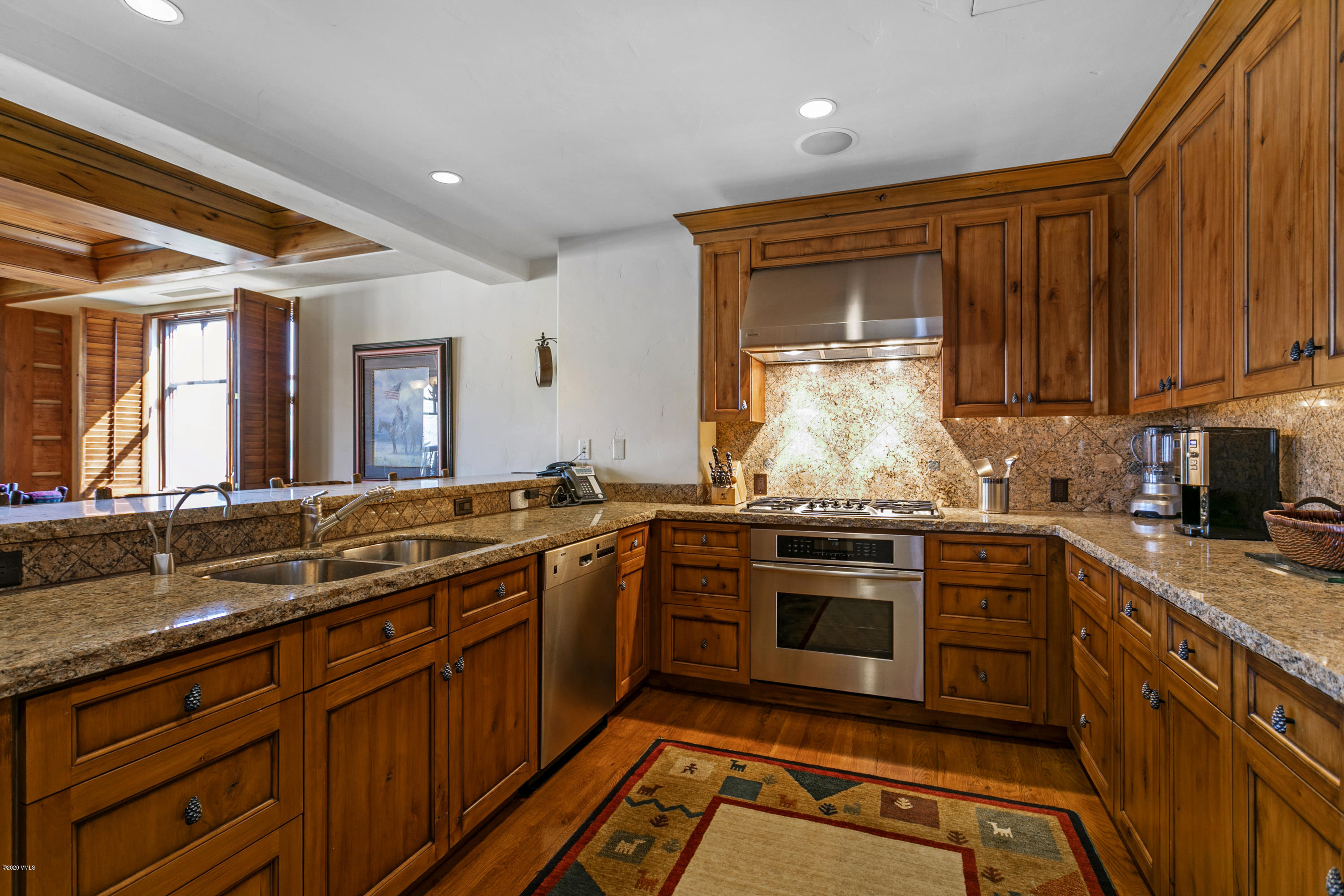 130 Daybreak Ridge Road, Unit R906 Avon, CO 81620 - Photo 6 of 26 a kitchen with stainless steel appliances granite countertop a stove sink and cabinets