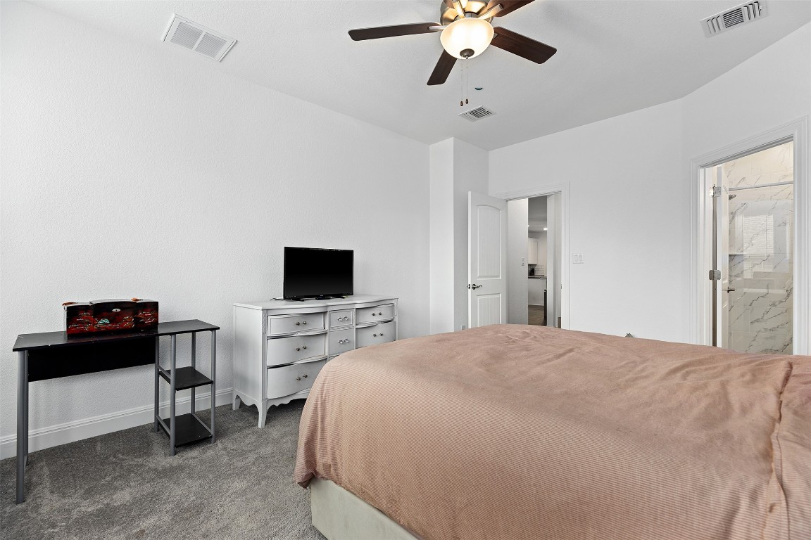 116 Raleigh Drive Georgetown, TX 78633 - Photo 11 of 24 a bedroom with a bed and a flat tv screen on wall