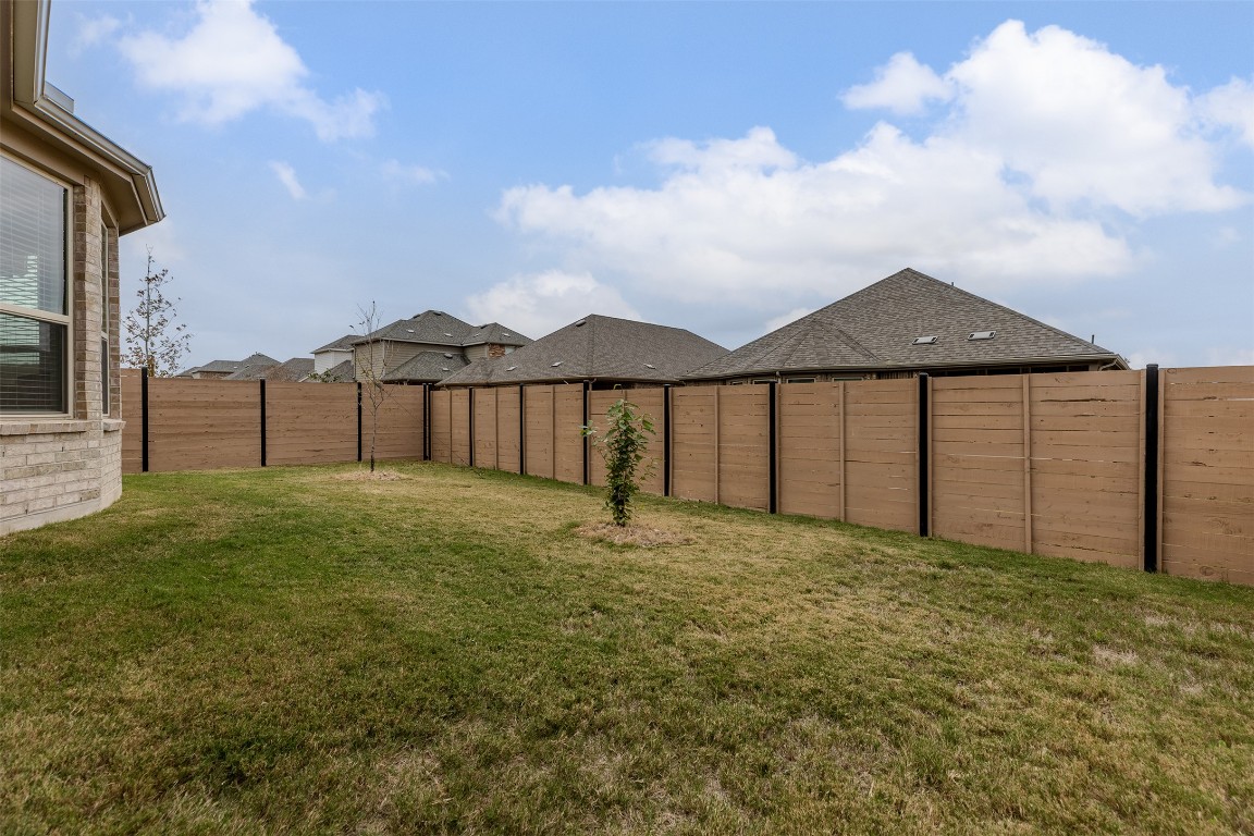 116 Raleigh Drive Georgetown, TX 78633 - Photo 23 of 24 a view of a yard with wooden fence