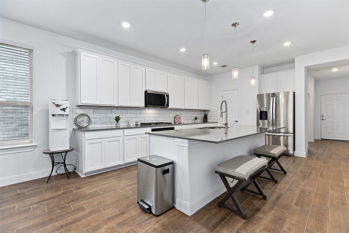 116 Raleigh Drive Georgetown, TX 78633 - Photo 5 of 24 a kitchen with sink cabinets and wooden floor
