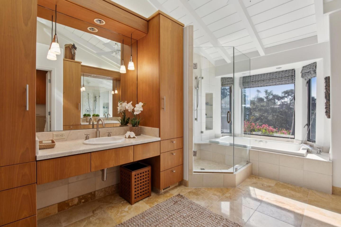 139 Boyd Way Carmel, CA 93923 - Photo 39 of 65 a bathroom with a double vanity sink a mirror and a bathtub