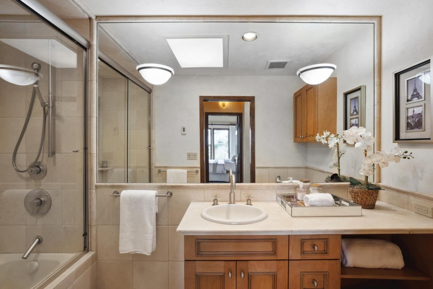 139 Boyd Way Carmel, CA 93923 - Photo 43 of 65 a bathroom with a granite countertop sink and a mirror