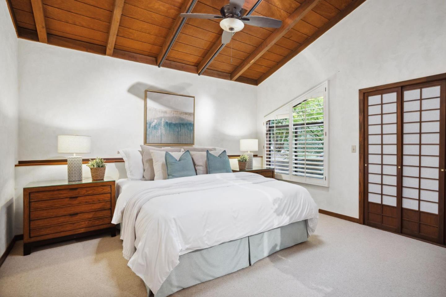 139 Boyd Way Carmel, CA 93923 - Photo 45 of 65 a spacious bedroom with a bed a dresser and next to a window