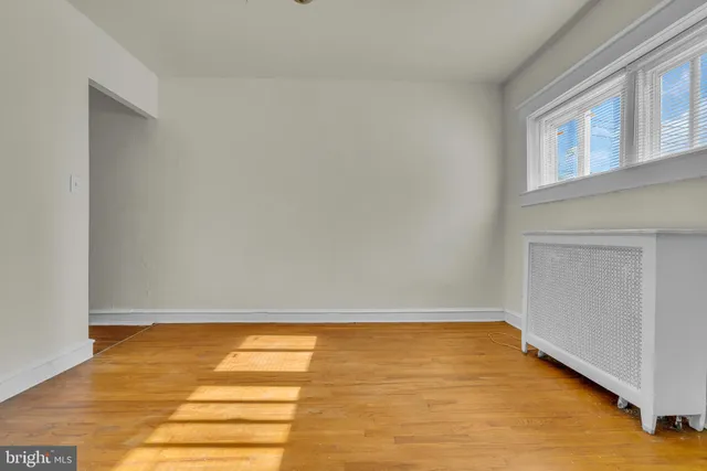 a view of room with window and wooden floor
