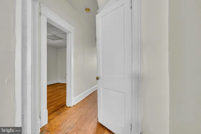 a view of hallway with wooden floor