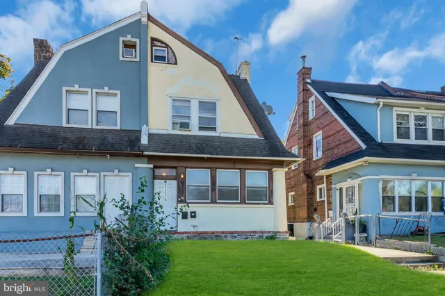 a front view of a house with a yard and porch