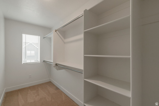 30 South Moonlit Road Mapleton, UT 84664 - Photo 12 of 25 Walk-in closet featuring built-in shelving, dual hanging rods, and a window with blinds