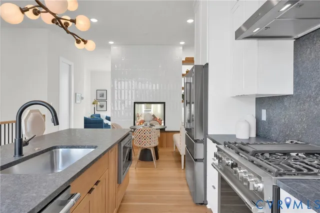 a kitchen with granite countertop a stove and a sink